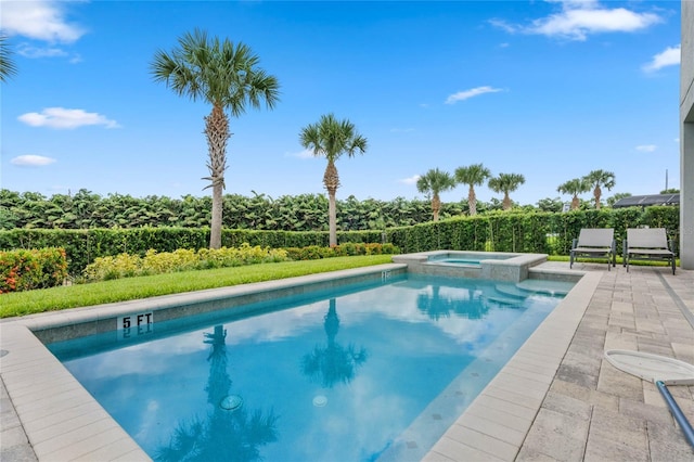 view of swimming pool with an in ground hot tub and a patio area