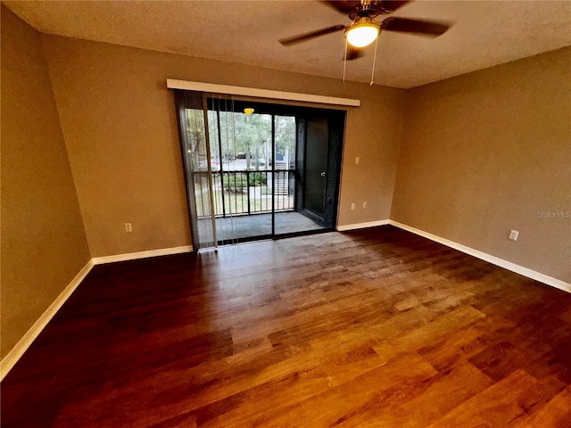 unfurnished room with ceiling fan, wood finished floors, and baseboards