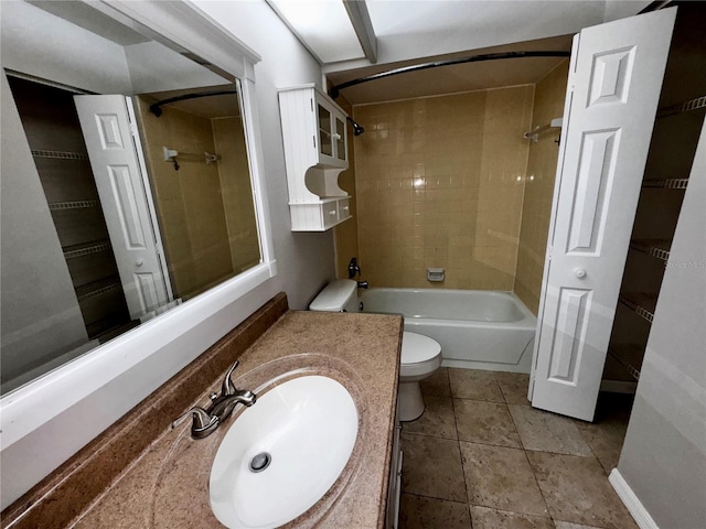 full bathroom featuring tiled shower / bath, tile flooring, toilet, and large vanity