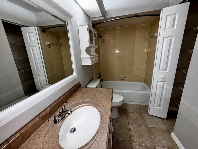 bathroom with toilet, tile patterned floors, washtub / shower combination, and vanity