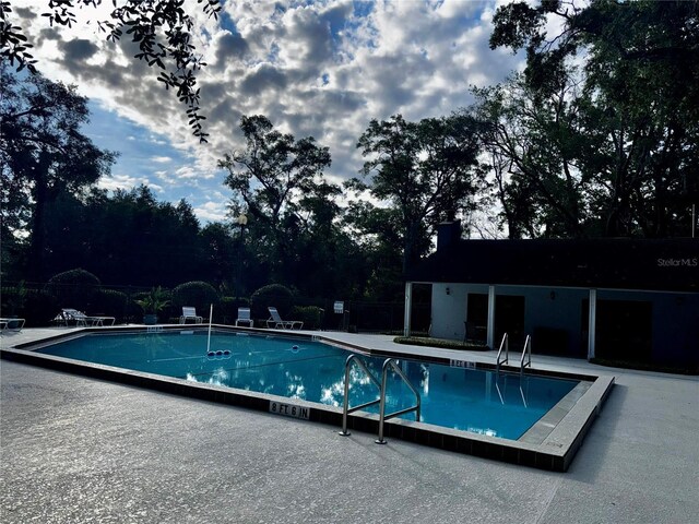 view of swimming pool featuring a patio area