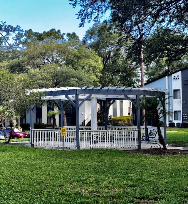 view of community with a pergola and a yard