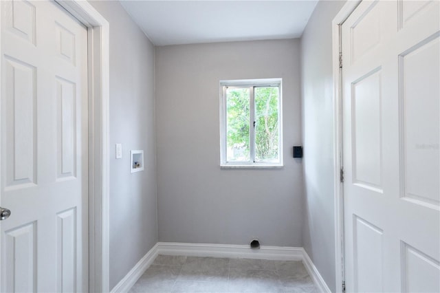 laundry area with light tile patterned floors and hookup for a washing machine