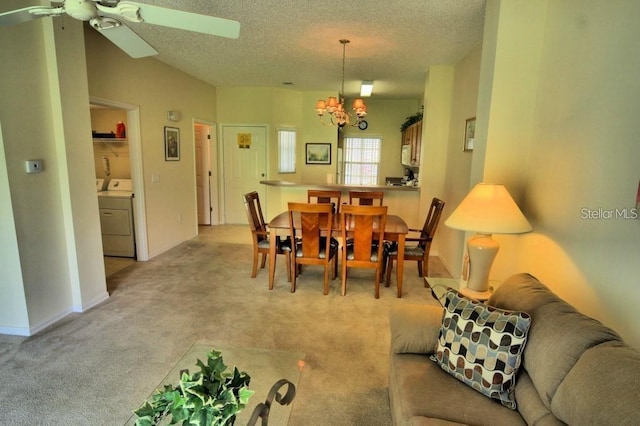 carpeted dining area with ceiling fan with notable chandelier and a textured ceiling