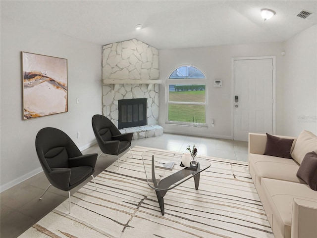 living room featuring a fireplace and light tile patterned flooring