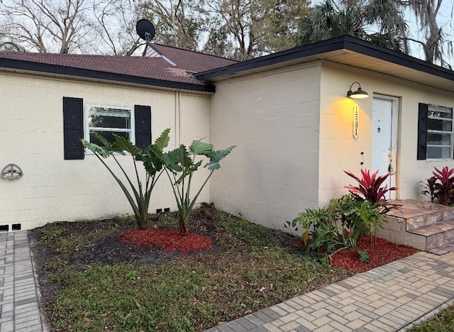 view of property exterior with concrete block siding