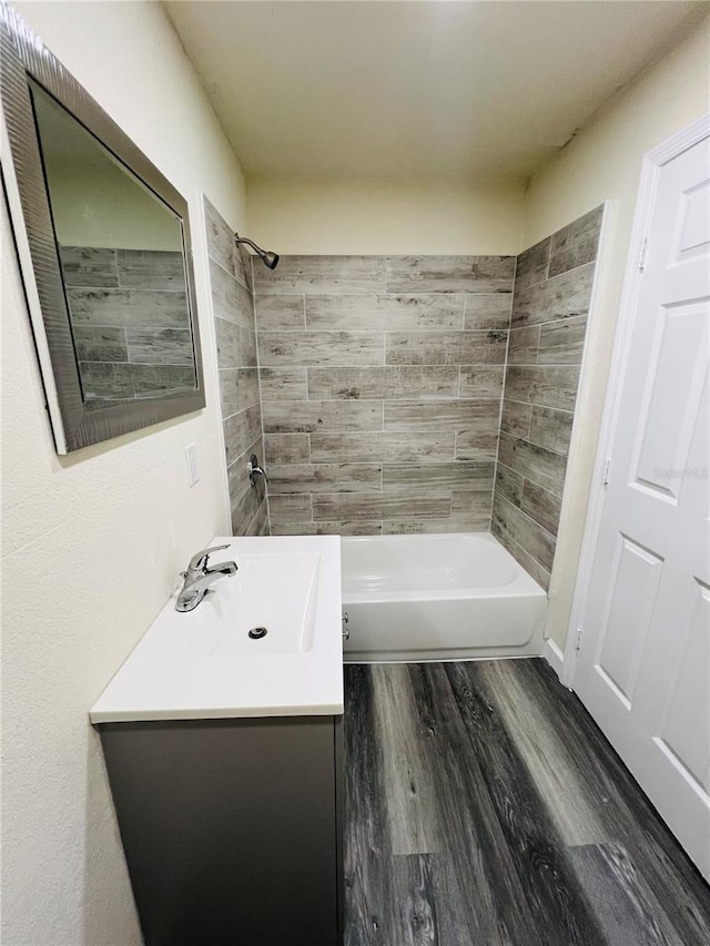 full bath featuring wood finished floors, shower / tub combination, and vanity