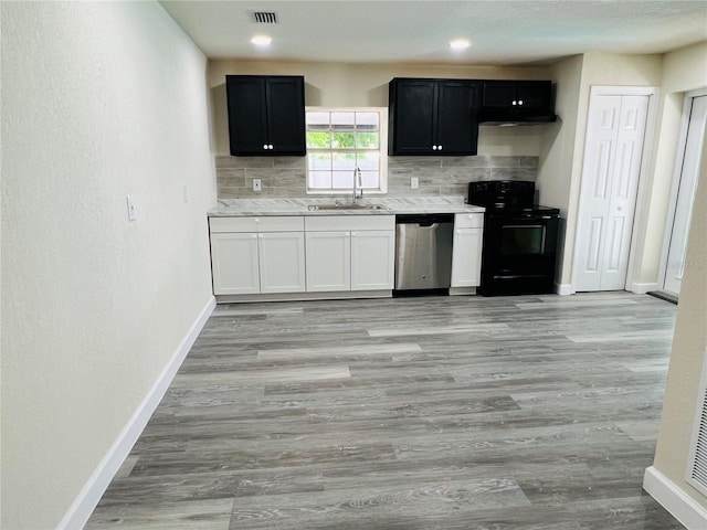 kitchen featuring visible vents, decorative backsplash, black electric range, stainless steel dishwasher, and a sink