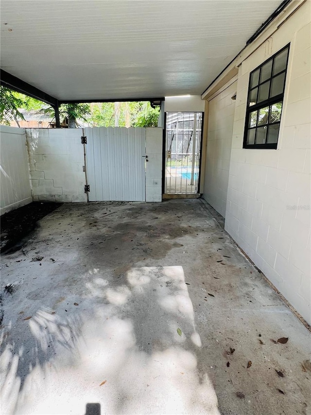 view of patio / terrace featuring a gate, fence, and an attached carport