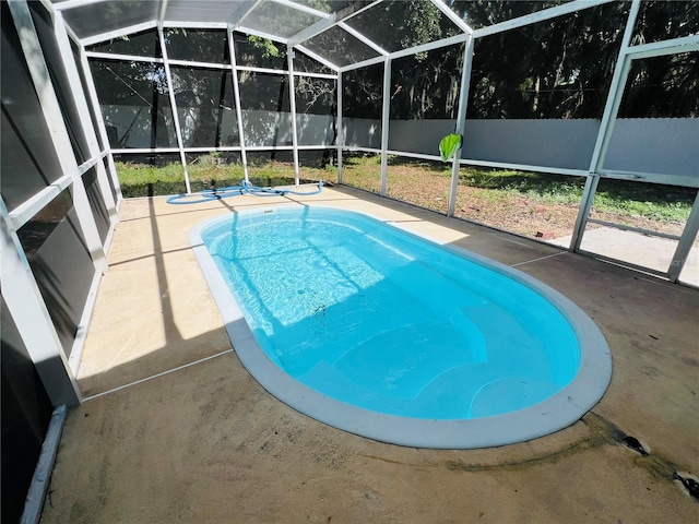 view of swimming pool with a fenced in pool, a lanai, a fenced backyard, and a patio