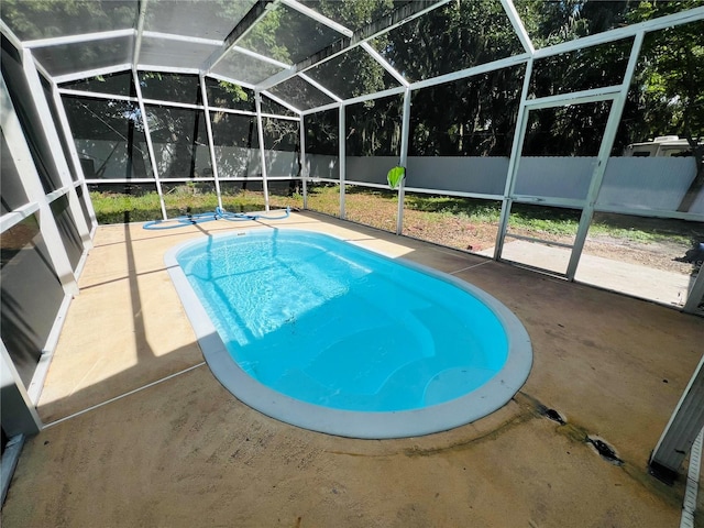 view of swimming pool with a lanai, a fenced backyard, a fenced in pool, and a patio