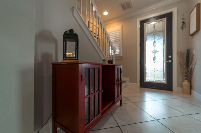 tiled entryway featuring ornamental molding