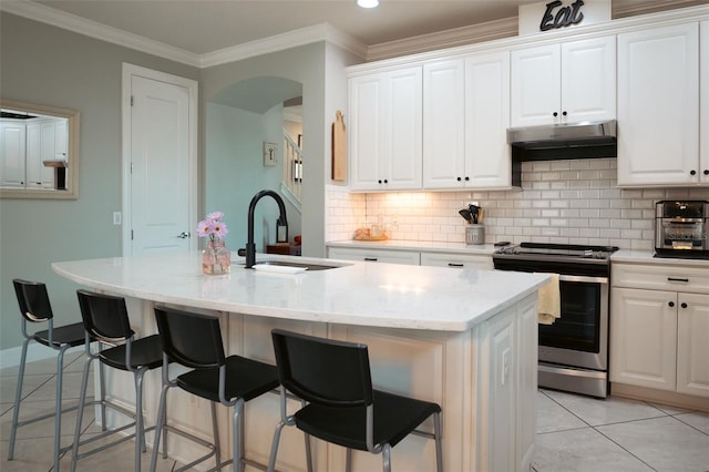 kitchen with sink, white cabinetry, an island with sink, and stainless steel stove