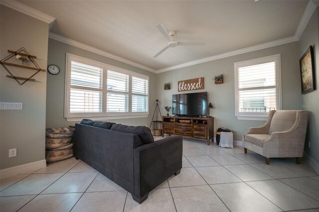 living room featuring light tile patterned floors, a wealth of natural light, ornamental molding, and ceiling fan