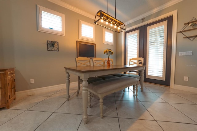 dining area featuring light tile patterned floors and crown molding