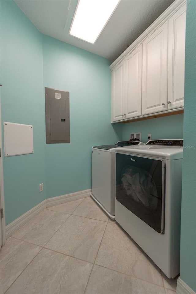 laundry room with cabinets, independent washer and dryer, electric panel, and light tile patterned flooring