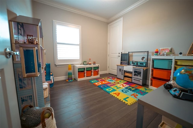 recreation room with dark hardwood / wood-style flooring and ornamental molding