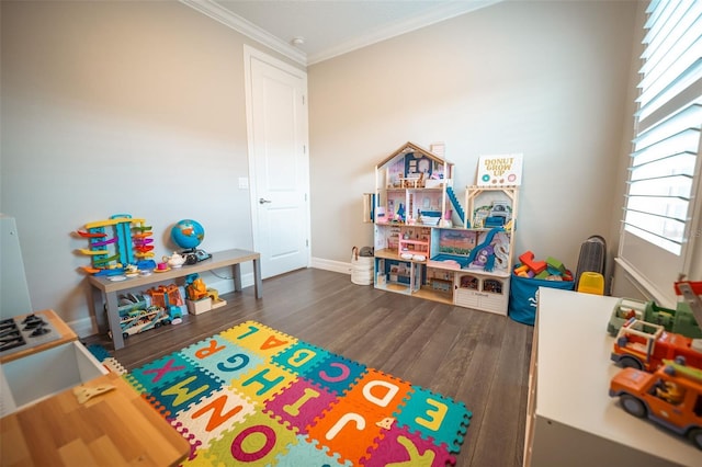 recreation room featuring dark hardwood / wood-style floors and ornamental molding