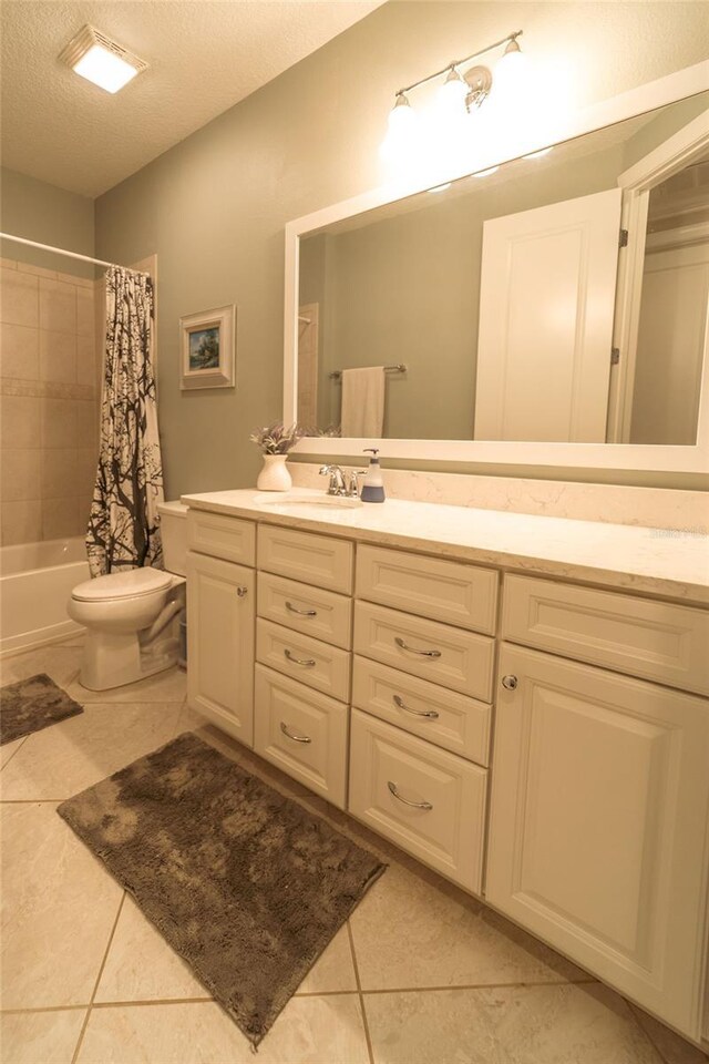 full bathroom with shower / bath combo, vanity, tile patterned flooring, toilet, and a textured ceiling