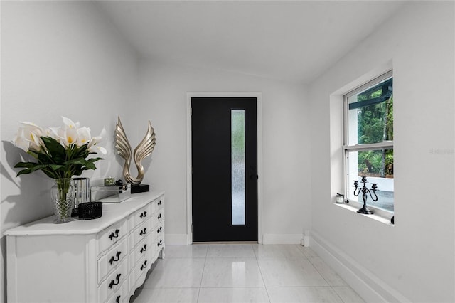 tiled entrance foyer with lofted ceiling