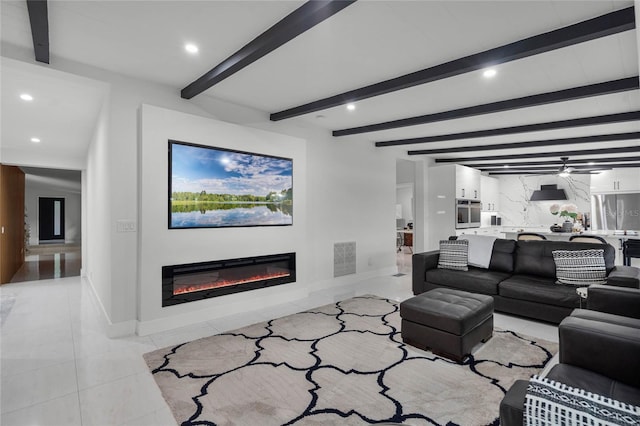 living room with beam ceiling, ceiling fan, and light tile patterned flooring