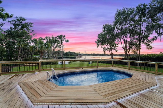 pool at dusk with a deck with water view