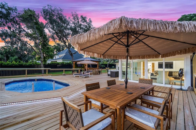 pool at dusk with a deck