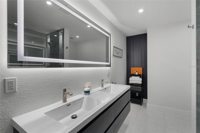 bathroom with tile patterned flooring, vanity, and a shower with shower door