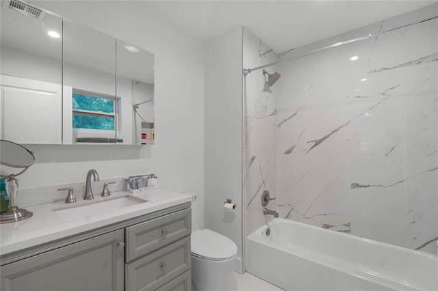 full bathroom featuring vanity, toilet, and tiled shower / bath