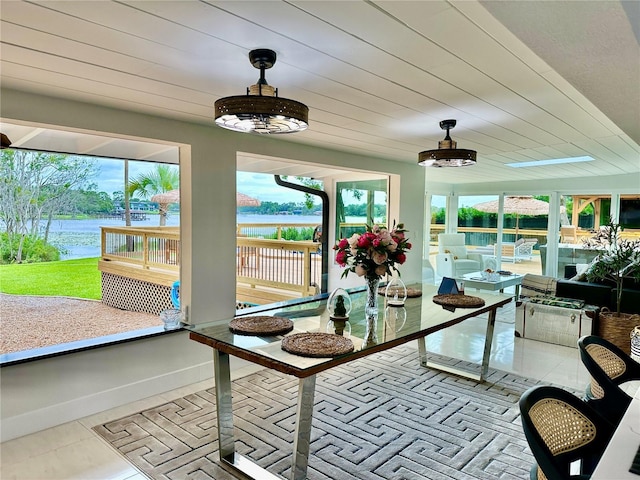 sunroom / solarium with a water view and wood ceiling