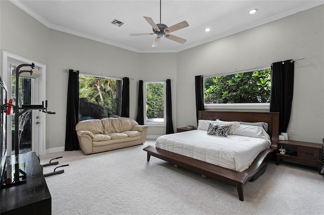 carpeted bedroom with ceiling fan and ornamental molding