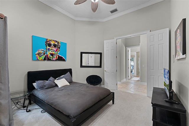 carpeted bedroom featuring ceiling fan and crown molding