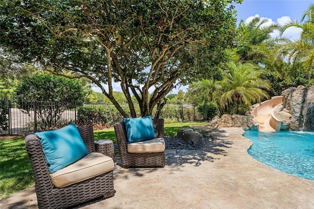 view of pool featuring pool water feature and a patio