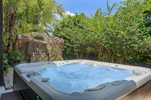 view of pool with a hot tub