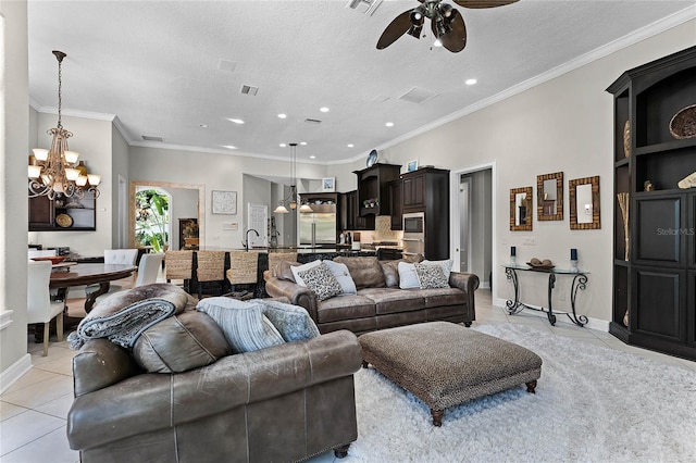 living room with built in features, a textured ceiling, light tile patterned flooring, ceiling fan with notable chandelier, and ornamental molding