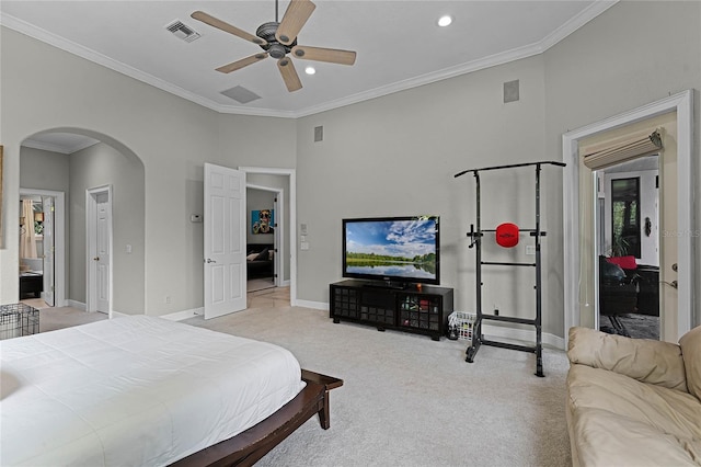 bedroom featuring ensuite bath, ceiling fan, light carpet, and ornamental molding