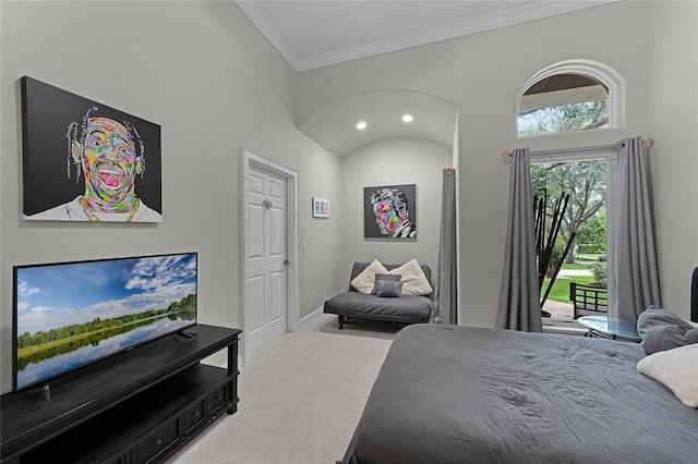 carpeted bedroom featuring access to exterior, a towering ceiling, and crown molding