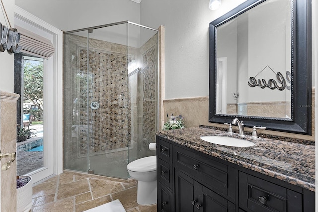 bathroom featuring vanity, an enclosed shower, and toilet