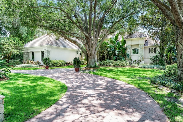 mediterranean / spanish house with a front yard