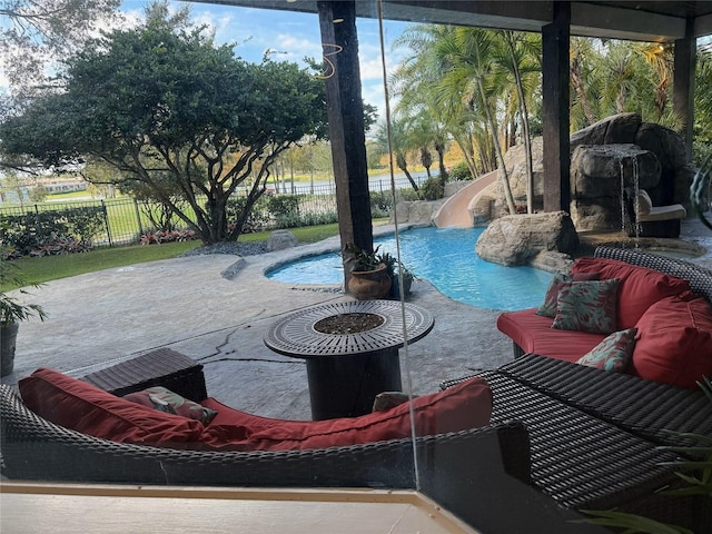 view of pool with an outdoor living space and a water slide