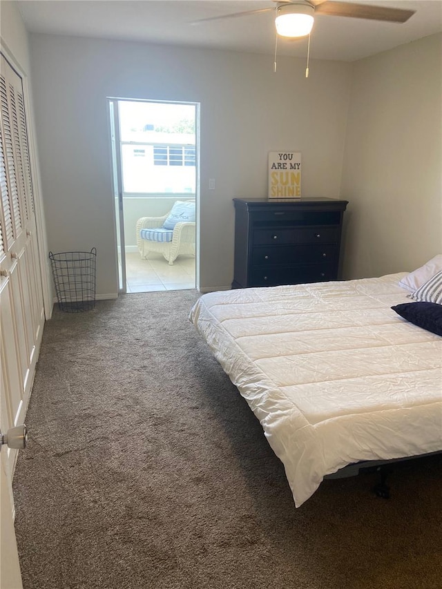 bedroom with ceiling fan, carpet floors, and a closet