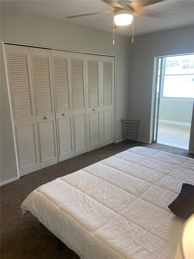 bedroom with ceiling fan, carpet floors, and a closet