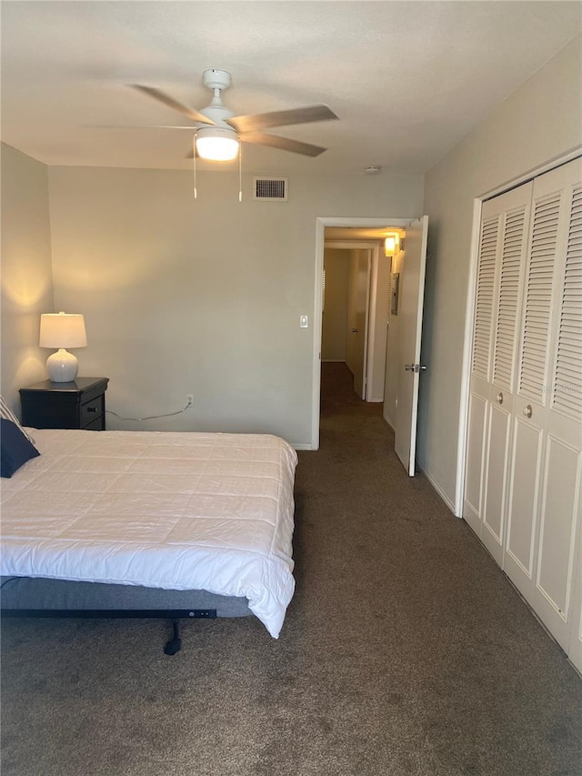 carpeted bedroom featuring a closet and ceiling fan