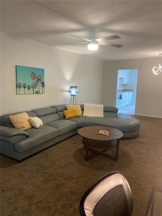 carpeted living room with ceiling fan