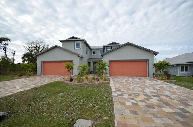 view of front facade with a garage and a front lawn