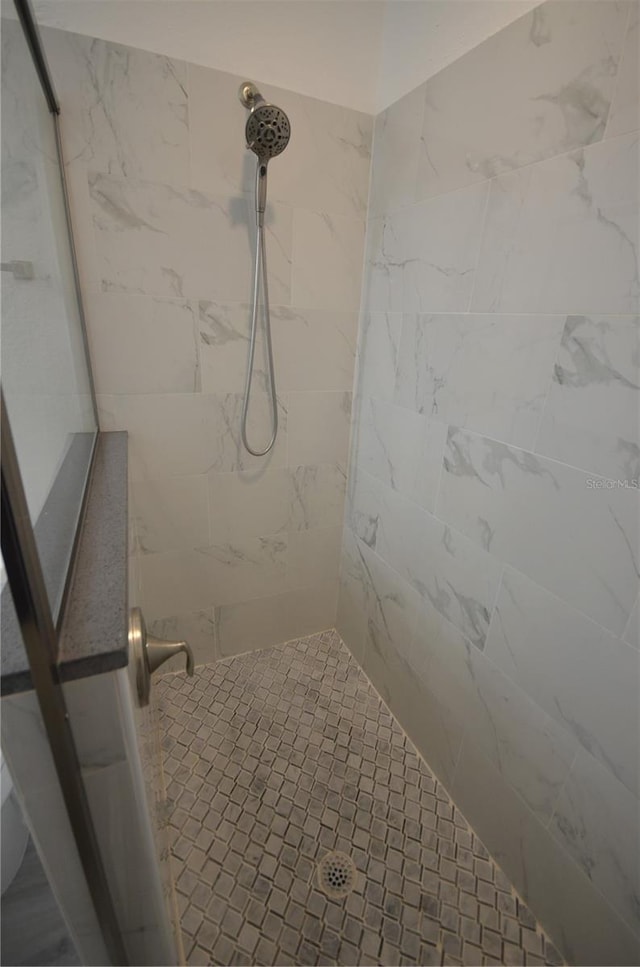 full bath with a tile shower