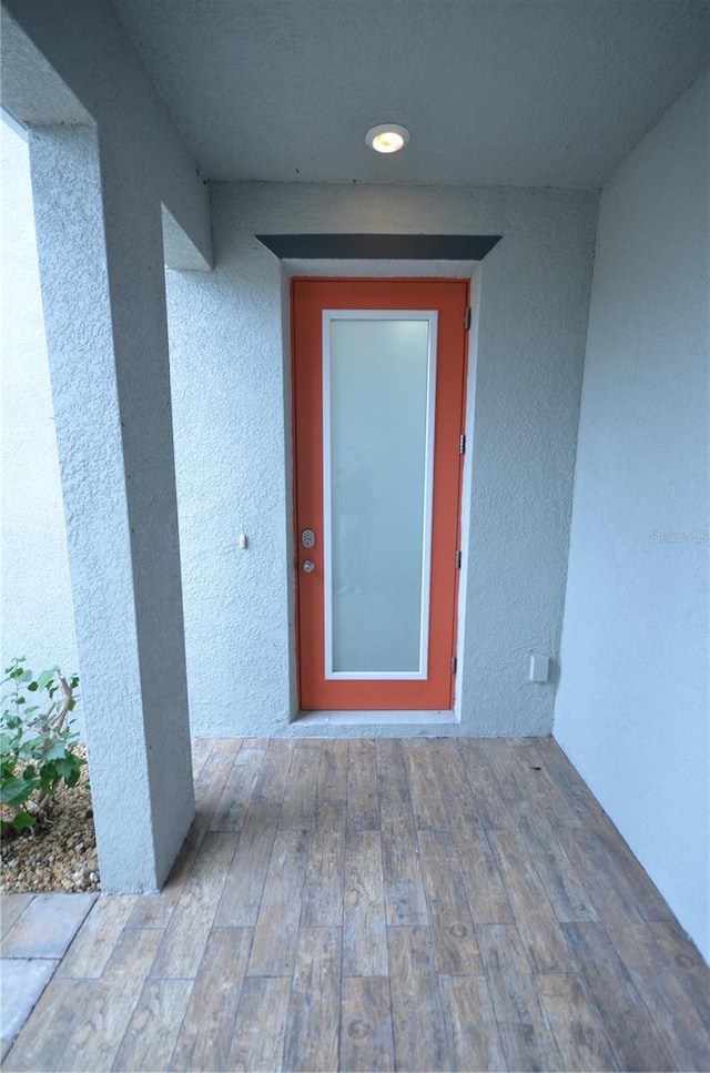 view of exterior entry featuring stucco siding