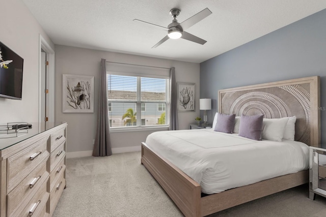 bedroom featuring ceiling fan and light carpet