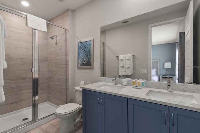 bathroom featuring walk in shower, tile patterned flooring, vanity, and toilet