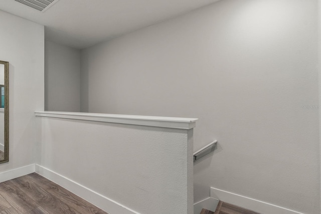 stairway featuring wood-type flooring